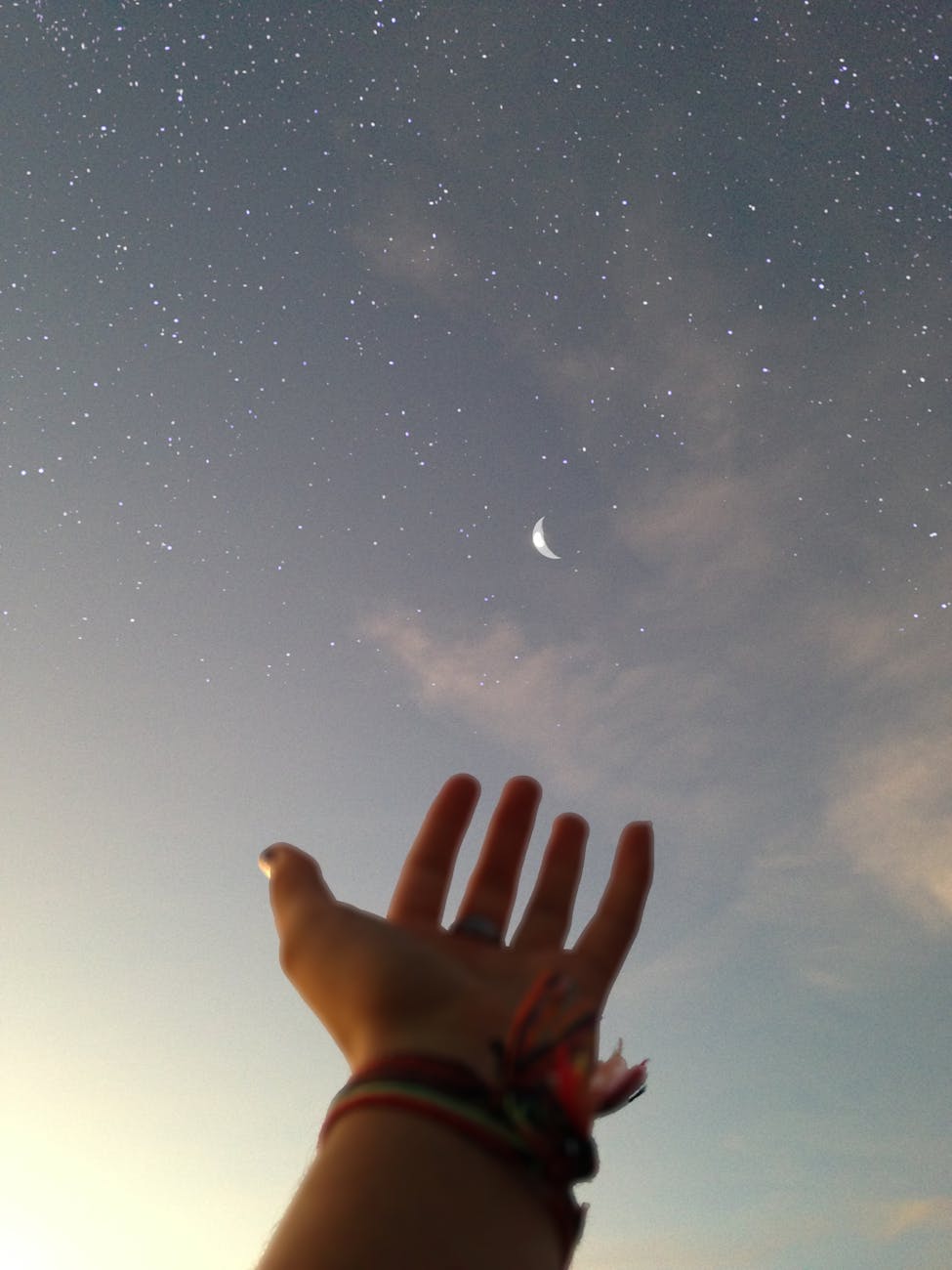 person s hand reaching for the sky